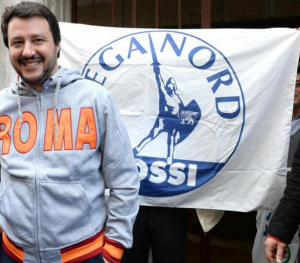 padania, salvini con la felpa con la scritta roma e dietro la bandiera della lega